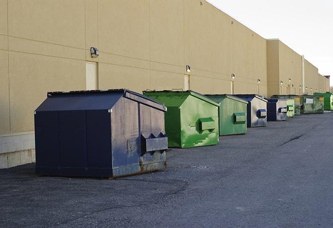 a series of colorful, utilitarian dumpsters deployed in a construction site in Martinsville